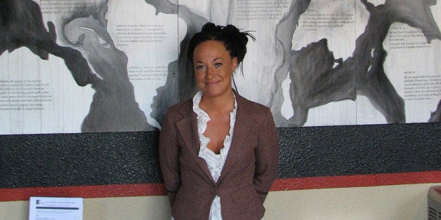 In this photo taken July 24, 2009, Rachel Dolezal, a leader of the Human Rights Education Institute, stands in front of a mur