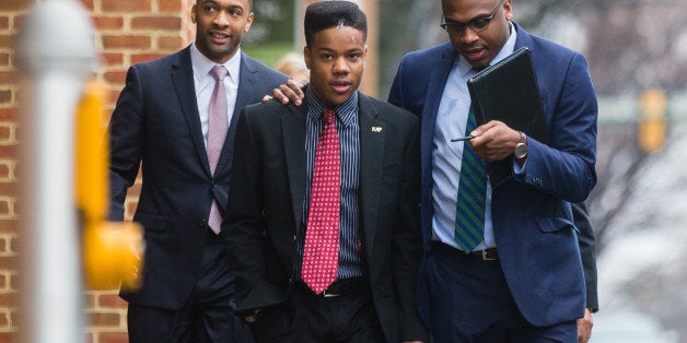 CHARLOTTESVILLE, VA - MARCH 26: University of Virginia student Martese Johnson (C) and his lawyer, Daniel Watkins (R) walk to