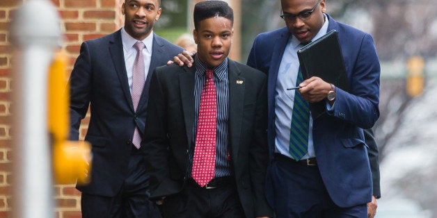 CHARLOTTESVILLE, VA - MARCH 26: University of Virginia student Martese Johnson (C) and his lawyer, Daniel Watkins (R) walk to the Charlottesville District Court before Johnson's hearing on March 26, 2015 in Charlottesville, Virginia. Johnson was arrested by Virginia's Alcoholic Beverage Control agents on March 18. Video in which Johnson appears bloodied, went viral after his arrest. His case was continued until 2015. (Photo by Zach Gibson/Getty Images)