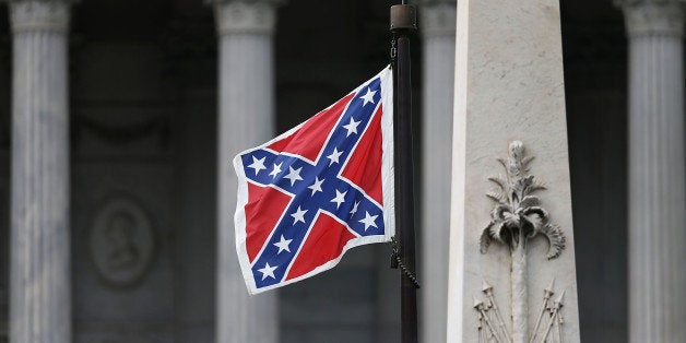 COLUMBIA, SC - JUNE 22: The Confederate flag flies on the Capitol grounds after South Carolina Gov. Nikki Haley announced that she will call for the Confederate flag to be removed on June 22, 2015 in Columbia, South Carolina. Debate over the flag flying at the Capitol was again ignited off after nine people were shot and killed during a prayer meeting at the Emanuel African Methodist Episcopal Church in Charleston, South Carolina. (Photo by Joe Raedle/Getty Images)