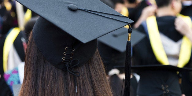 Rear view of graduation caps during commencement.