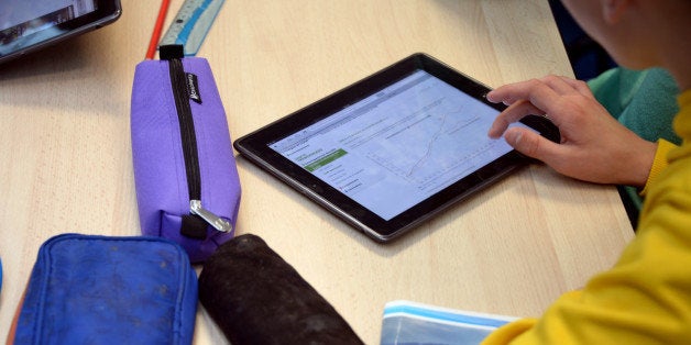 A pupil uses a tablet during courses in a classroom at the Leonard de Vinci 'connected' middle school in Saint-Brieuc, western France on September 12, 2013. The Leonard de Vinci school is one of the 23 middle schools in France to be connected to the internet and to be using new information technologies during courses. AFP PHOTO / DAMIEN MEYER (Photo credit should read DAMIEN MEYER/AFP/Getty Images)