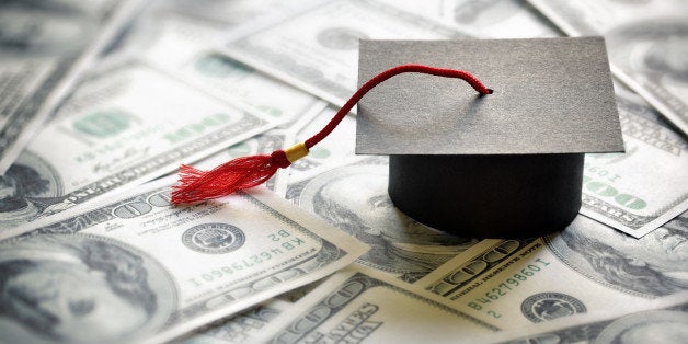 Graduation mortar board cap on one hundred dollar bills concept for the cost of a college and university education