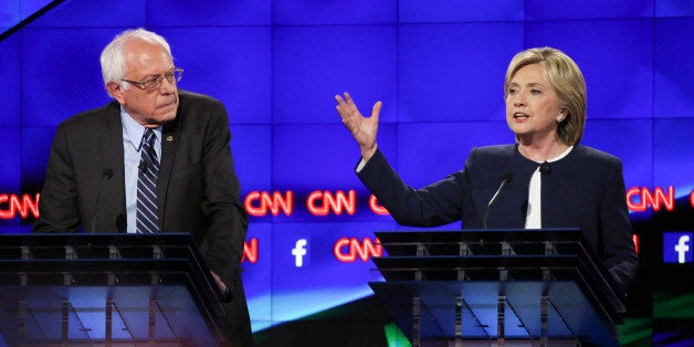 Hillary Clinton, former U.S. secretary of state, right, and Senator Bernie Sanders, an independent from Vermont, participate in the first Democratic presidential debate at the Wynn Las Vegas resort and casino in Las Vegas, Nevada, U.S., on Tuesday, Oct. 13, 2015. While tonight's first Democratic presidential debate will probably lack the name-calling and sharp jabs of the Republican face-offs, there's still potential for strong disagreements between the party's leading contenders. Photographer: Josh Haner/Pool via Bloomberg 