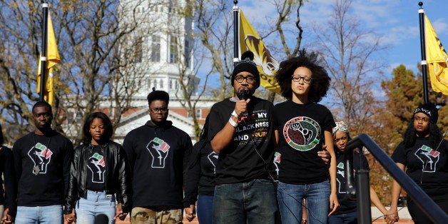 FILE - In this Nov. 9, 2015, file photo, graduate student Jonathan Butler, center, addresses a crowd following the announcement that University of Missouri System President Tim Wolfe would resign, in Columbia, Mo. On the day he met with black players for the University of Missouriâs football team, Butler hadnât eaten for six days. (AP Photo/Jeff Roberson, File)