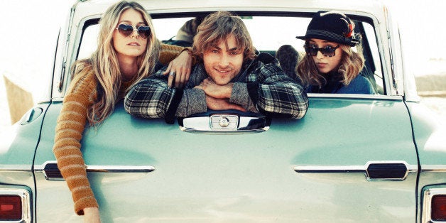 Friends hanging out in the back of a car.