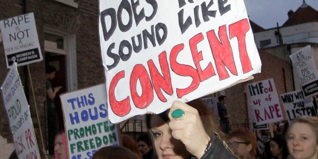 Protesters march through the streets to the Cambridge University Students' Union in Cambridge, England, in protest of former