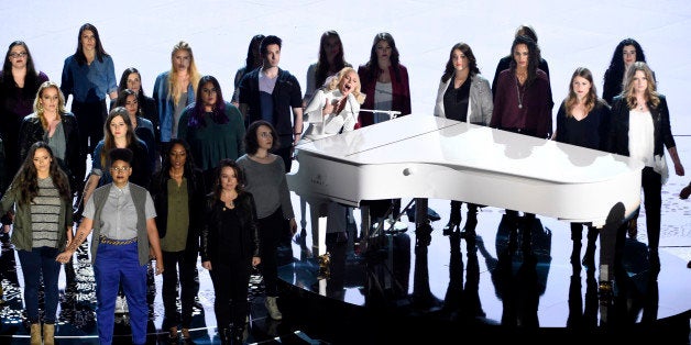 Lady Gaga performs with survivors of abuse at the Oscars on Sunday, Feb. 28, 2016, at the Dolby Theatre in Los Angeles. (Phot