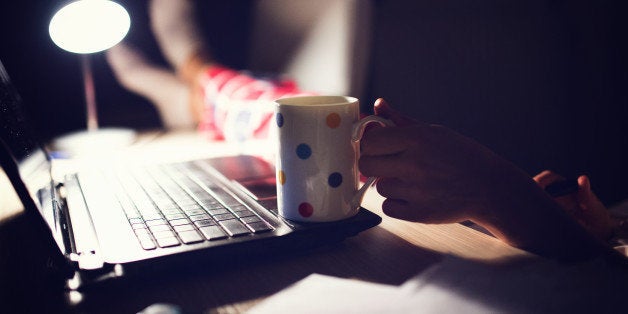 Photo of womans hand holding coffee ,making a pause after work