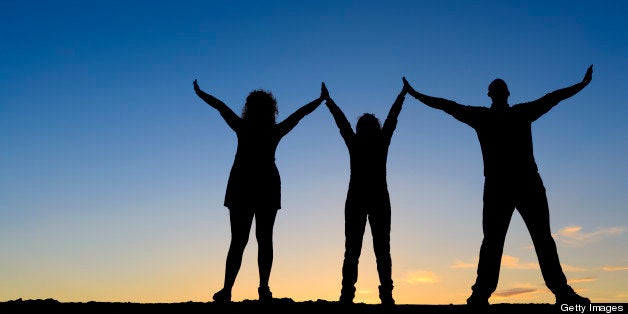 free friends silhouette holding arms raised.