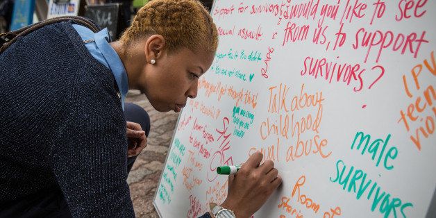 LOS ANGELES, CA - JUNE3: Passers-by write messages to sexual assault victims during an event held by the organization 7000 in Solidarity, on UCLA's campus June 4th, 2015, to pay respect to the 7,000 Bruins who have or will experience sexual violence over the course of their lifetime, before the organization transitions to its new name, Bruin Consent Coalition. 1 in 3 women and 1 in 6 men will experience sexual violence over the course of our lifetime. That means of the 28,000 undergraduates at UCLA, 7,000 Bruins will experience sexual violence. (Photo by Evelyn Hockstein/For The Washington Post via Getty Images)
