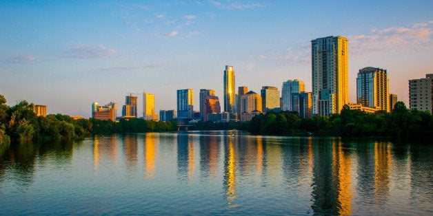 Austin Texas 2015 Capital City beauty in the central Texas hill country the Texas state capital glows in the sunrise as the sunrise / sunset hits the upper Towers and skyscrapers of the downtown district 