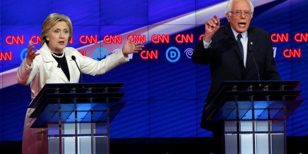 Democratic U.S. presidential candidates Hillary Clinton (L) and Senator Bernie Sanders speak simultaneously during a Democrat