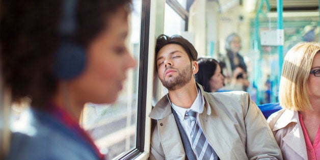 Businessman napping on train