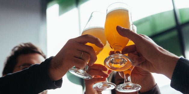 Group Of Friends Toasting In Tavern