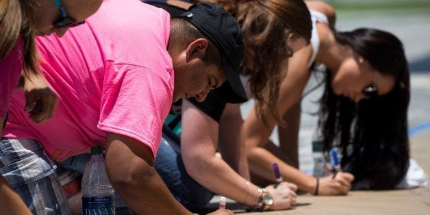 ORLANDO, USA - JUNE 13: Mourners leave notes for the victims of the Pulse nightclub and First Responders at a make shift memorial at Phillips Center for the Performing Arts in Orlando, USA on June 13, 2016. (Photo by Samuel Corum/Anadolu Agency/Getty Images)