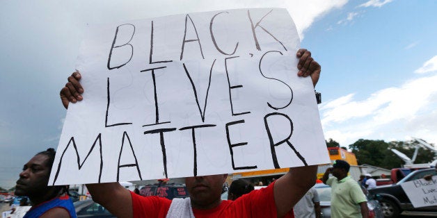 Demonstrators encourage passing motorists to honk outside the Triple S convenience store in Baton Rouge, La., Wednesday, July 6, 2016. Alton Sterling, 37, was shot and killed outside the store by Baton Rouge police, where he was selling CDs. (AP Photo/Gerald Herbert)