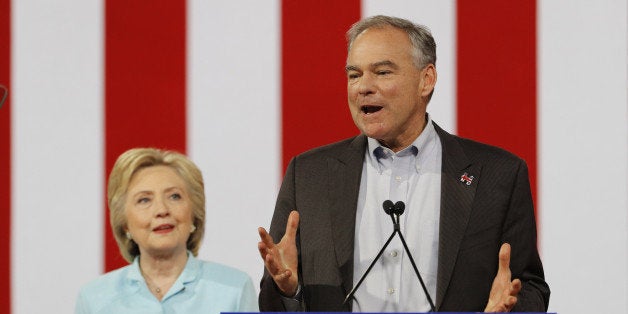 Democratic U.S. presidential candidate Hillary Clinton listens to her running-mate, Democratic U.S. vice presidential candida