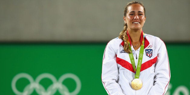 RIO DE JANEIRO, BRAZIL - AUGUST 13: Gold medalist Monica Puig of Puerto Rico reacts during the medal ceremony for Women's Singles on Day 8 of the Rio 2016 Olympic Games at the Olympic Tennis Centre on August 13, 2016 in Rio de Janeiro, Brazil. (Photo by Clive Brunskill/Getty Images)