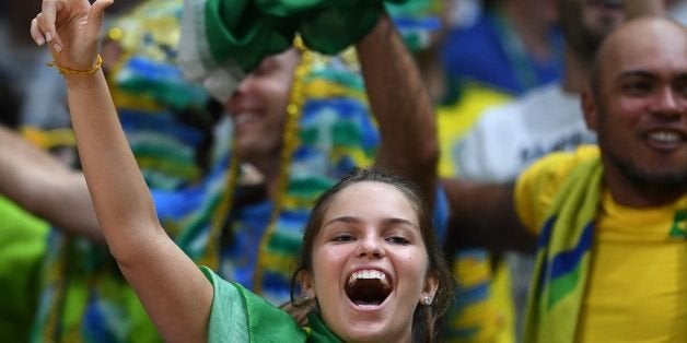 A Brazil fan cheers during the men's Gold Medal volleyball match between Italy and Brazil at the Maracanazinho stadium in Rio