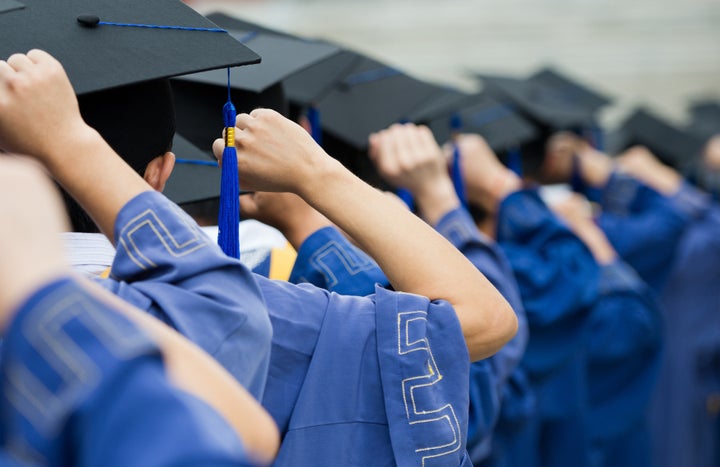 back of graduates put hands up...
