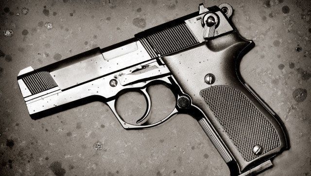 classic black pistol on rusty...