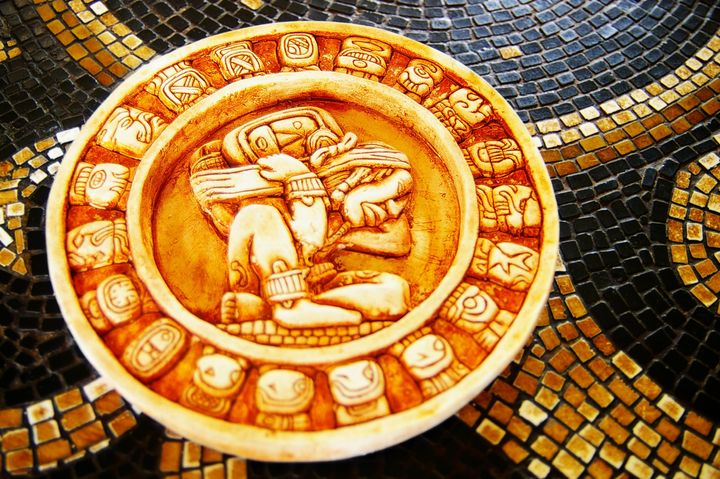 carved stone mayan calendar on...