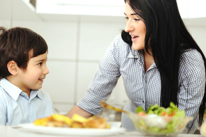 little boy in kitchen with...