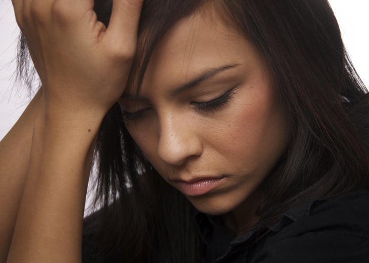 sad young woman looking down ...