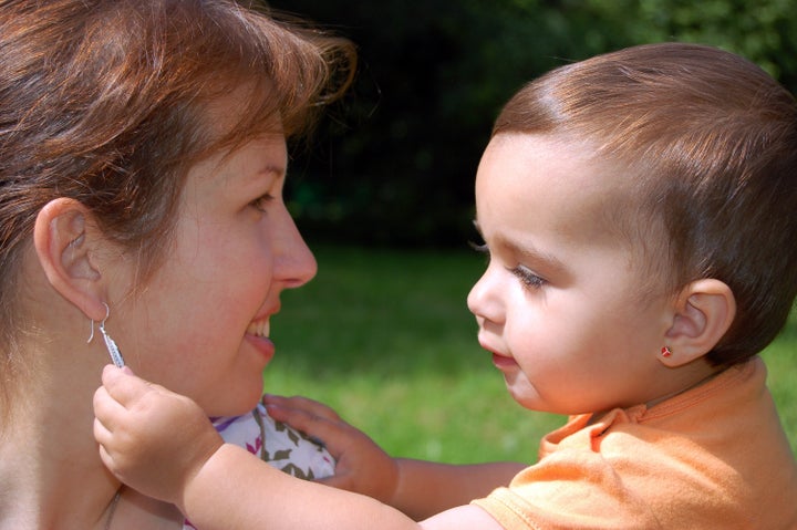 a child watching her mother's...