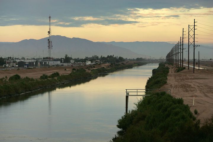 CALEXICO, CA - OCTOBER 03: The All American Canal, where new border fencing is proposed, is seen on the US side of the US-Mexico border on October 3, 2007 east of Calexico, California. Many people have died swimming across the canal after crossing the border. Recent US federal construction of border fences has rapidly sped up. The sudden acceleration marks a change from a month ago when the Department of Homeland Security (DHS) announced that it would have only completed 15 of 70 miles of new fencing promised by the end of September, enraging anti-illegal-immigration groups and many Republicans. Instead, the DHS reached its goal of 70 miles to raise the total amount of border fences from 75 to about 145 miles. The fence-building frenzy is the result of the controversial Secure Fence Act, passed last fall, calling for 698 miles of border fences. Critics argue that extensive fencing will damage fragile desert environments, divide border neighborhoods, and that illegal immigrants will continue to find ways over, under, and through the fence or simply go around it elsewhere along the 2000-mile-long international border. Supporters believe that it will hinder border crossers. (Photo by David McNew/Getty Images)