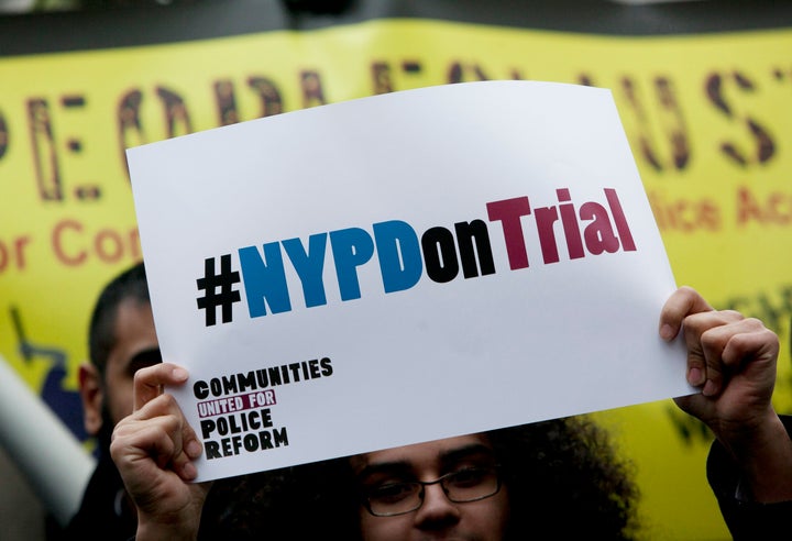 NEW YORK, NY - MARCH 18: A woman holds a sign during a demonstration against the city's 'stop and frisk' searches in lower Manhattan near Federal Court March 18, 2013 in New York City. Hearings in a federal lawsuit filed by four black men against the city police department's 'stop and frisk' searches starts today in Manhattan Federal Court. (Photo by Allison Joyce/Getty Images)