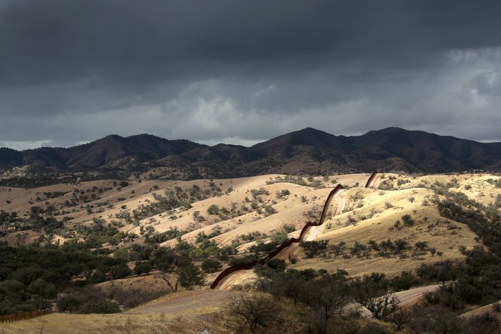 NOGALES, AZ - MARCH 08: The U.S.-Mexico border fence stretches into the countryside on March 8, 2013 near Nogales, Arizona. U.S. Border Patrol agents in Nogales say they have seen a spike in immigrants crossing into the United States from Mexico in the last week. (Photo by John Moore/Getty Images)