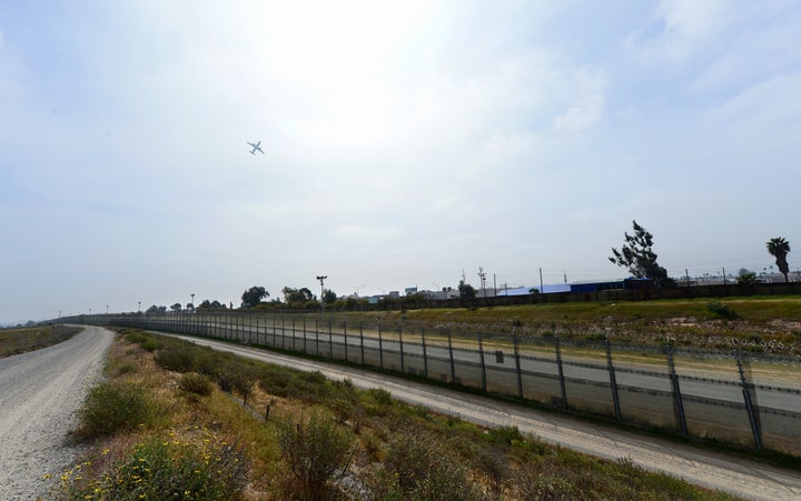 TO GO WITH AFP STORY BY LEILA MACOR 'EEUU-MIGRACIÓN-SEGURIDAD-HISPANOS' An airplane flies over the US-Mexico border between the Otay Mesa and San Ysidro port of entries in and near San Diego, California, across from Tijuana, Mexico on April 4, 2013. The barrier separating the two countries is in reality several barriers, designed to prevent illegal movement across the border, backed by supporters and criticized by opponents. AFP PHOTO/Frederic J. BROWN (Photo credit should read FREDERIC J. BROWN/AFP/Getty Images)