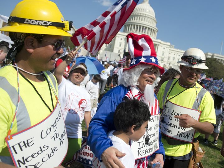 A man dressed as Uncle Sam poses for photos as tens of thousands of immigration reform supporters march in the 'Rally for Citizenship' on the West Lawn of the US Capitol in Washington, DC, on April 10, 2013. AFP PHOTO / Saul LOEB (Photo credit should read SAUL LOEB/AFP/Getty Images)