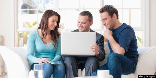 Hispanic couple talking with financial advisor