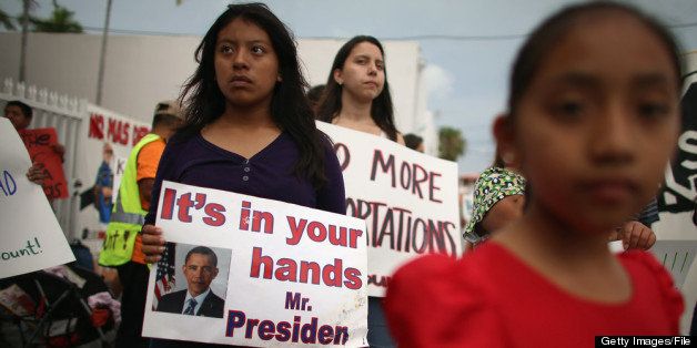 HOMESTEAD, FL - MAY 11: Elena Marquez (L) holds a sign reading 'it's in your hands Mr. President' as she and others participate in a rally calling on the President Barack Obama to immediately suspend deportations and for Congress to pass an immigration reform that?s inclusive of all 11 million undocumented people in the U.S. on May 11, 2013 in Homestead, Florida. The rally is part of what is being called a rolling fast in different places throughout the nation over the course of the next two months to bring what organizers say is a moral, prophetic voice to the immigration debate. (Photo by Joe Raedle/Getty Images)