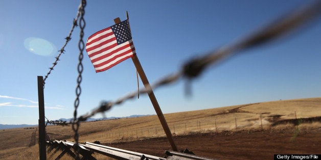 SONOITA, AZ - FEBRUARY 26: An American flag flies at the U.S.-Mexico border on February 26, 2013 near Sonoita, Arizona. The Federal government has increased the Border Patrol presence in Arizona, from some 1,300 agents in the year 2000 ro 4,400 in 2012. The apprehension of undocumented immigrants crossing into the U.S. from Mexico has declined during that time from 600,016 in 2000 to 123,000 in 2012. (Photo by John Moore/Getty Images)