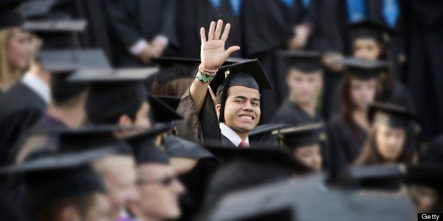 College graduate waving