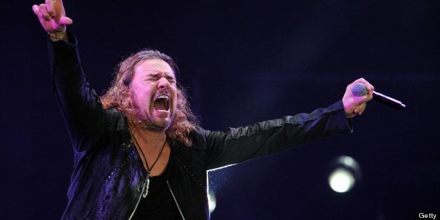 Mexican singer Fernando Olvera (R) of the band Mana performs during the 'Drama y Luz' World Tour at the National Footbal Stadium in Managua on March 16, 2013. AFP PHOTO / Hector RETAMAL (Photo credit should read HECTOR RETAMAL/AFP/Getty Images)