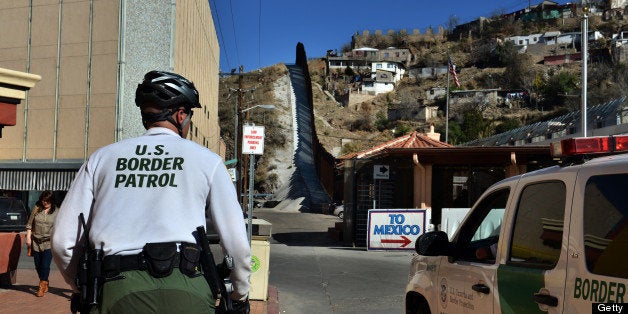 NOGALES, AZ - MARCH 2: U.S. Border Patrol officers patrol the streets of downtown Nogales, Arizona, with Nogales, Mexico, standing on the other side of the international border fence on Saturday, March 2, 2013, in Nogales, AZ, United States. (Photo by Jahi Chikwendiu/The Washington Post via Getty Images)