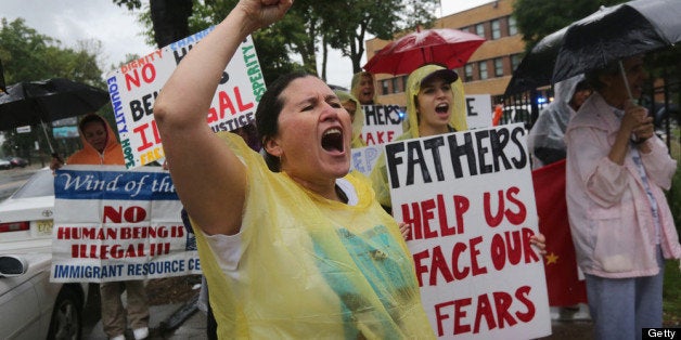 NEWARK, NJ - JUNE 13: Immigrant rights activist Diana Mejia and fellow protesters stage a demonstration in front of the Immigration and Customs Enforcement (ICE), office on June 13, 2013 in Newark, New Jersey. Immigrant advocacy groups nationwide are scheduling protests ahead of Father's Day to draw attention to the high number family separations due to the deportation of parents as undocumented immigrants. (Photo by John Moore/Getty Images)