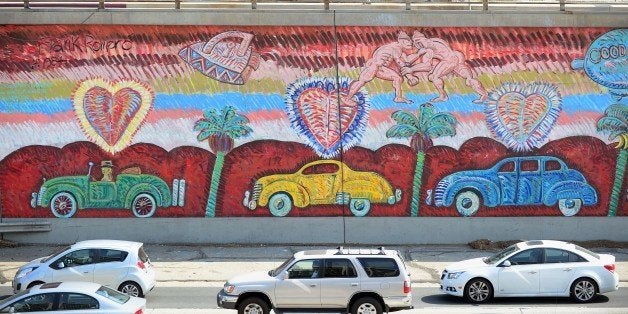 Traffic going north on US 101 flows past Frank Romero's 'Going to the Olympics' mural in Los Angeles on August 15, 2013 in California. Considered one of Los Angeles's prized possessoins, the 'Going to the Olympics' murals were commissioned in 1984, part of ten pieces created for the Olympic Arts Festival in commemoration of the city hosting the 1984 Summer Games. AFP PHOTO/Frederic J. BROWN (Photo credit should read FREDERIC J. BROWN/AFP/Getty Images)