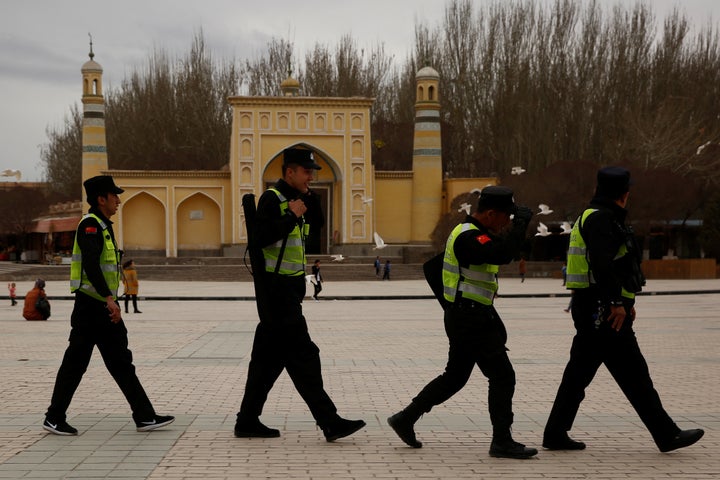 A police patrol walk in front of the Id Kah Mosque in the old city of Kashgar, Xinjiang Uighur Autonomous Region, China.