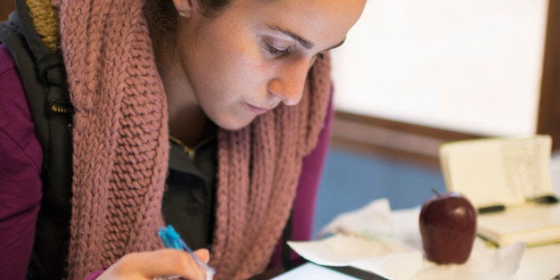 Hispanic college student with tablet & smartphone