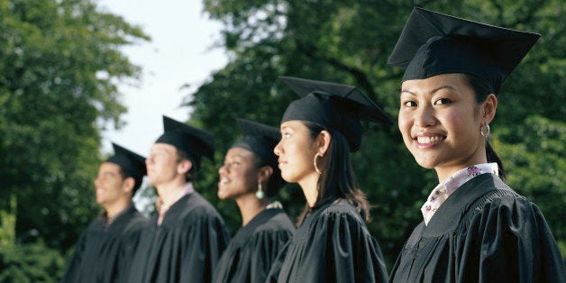Row of graduates, focus on female graduate smiling
