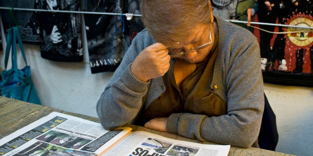 TO GO WITH AFP STORY BY LAURENT THOMETMaria Teresa Ramos, grandmother of Jerzi Esli, kidnapped with other 11 people from a bar in May, reads a newspaper on August 23, 2013, in the popular neighborhood of Tepito, in Mexico City. The victims were kidnapped from a downtown bar in broad daylight on a Sunday morning three months ago in a case that raised concerns about security in Mexico City, which has been relatively immune from the country's drug cartel violence. AFP PHOTO/RONALDO SCHEMIDT (Photo credit should read Ronaldo Schemidt/AFP/Getty Images)