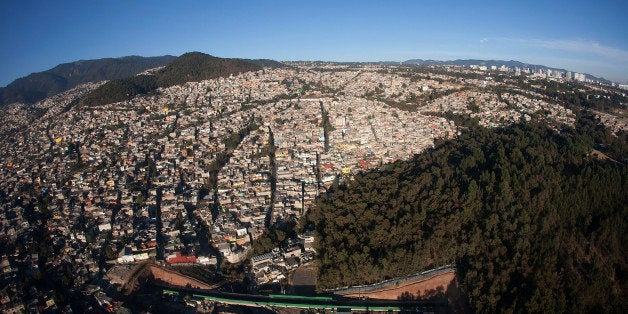 Residential homes sit in the Santa Fe neighborhood as seen in this aerial photograph taken from a helicopter in the Condor Group, a fleet of helicopters operated by the Federal District Secretariat of Public Security, in Mexico City, Mexico, on Friday, Feb. 15, 2013. The group provides air support to the population of Mexico City in emergencies, as well as surveillance and traffic monitoring. Photographer: Susana Gonzalez/Bloomberg via Getty Images