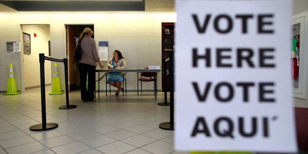 MANSFIELD, TX - NOVEMBER 06: An election official answers a question for a voter on November 6, 2012 in Mansfield, Texas. Am