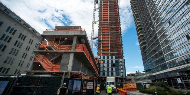 Contractors arrive at the site of a condominium under construction in the borough of Brooklyn, New York, U.S., on Monday, Sept. 16, 2013. The U.S. Census Bureau is scheduled to release housing starts figures on Sept. 18. Photographer: Craig Warga/Bloomberg via Getty Images